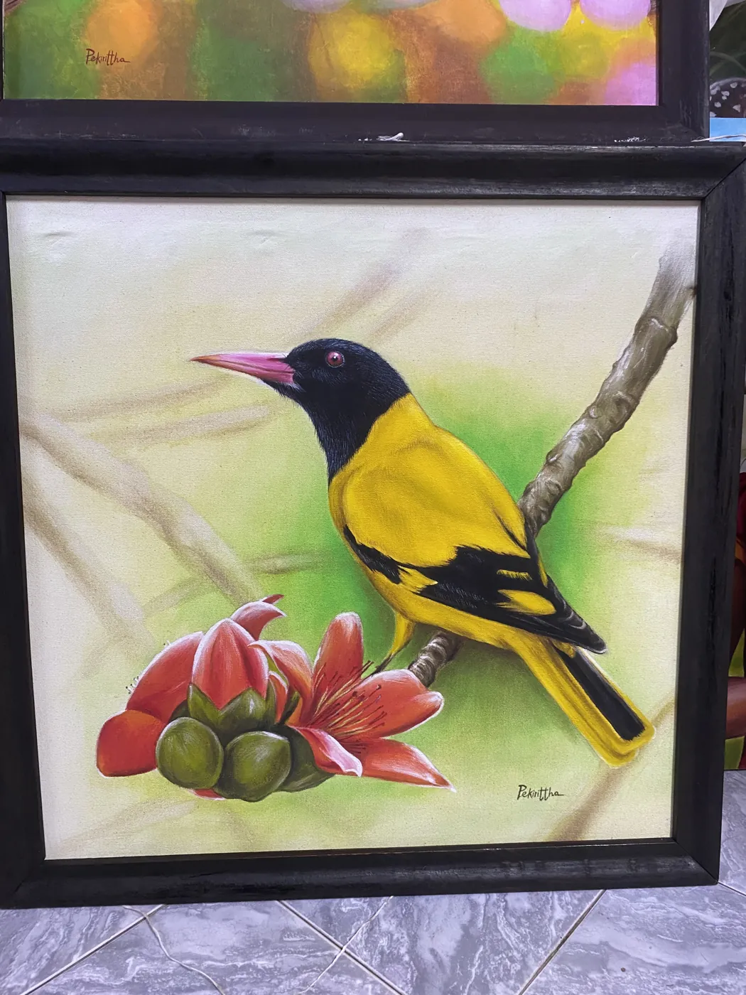 Framed hand painting of a black hooded oriole on a flowering branch by a Sri Lankan artist