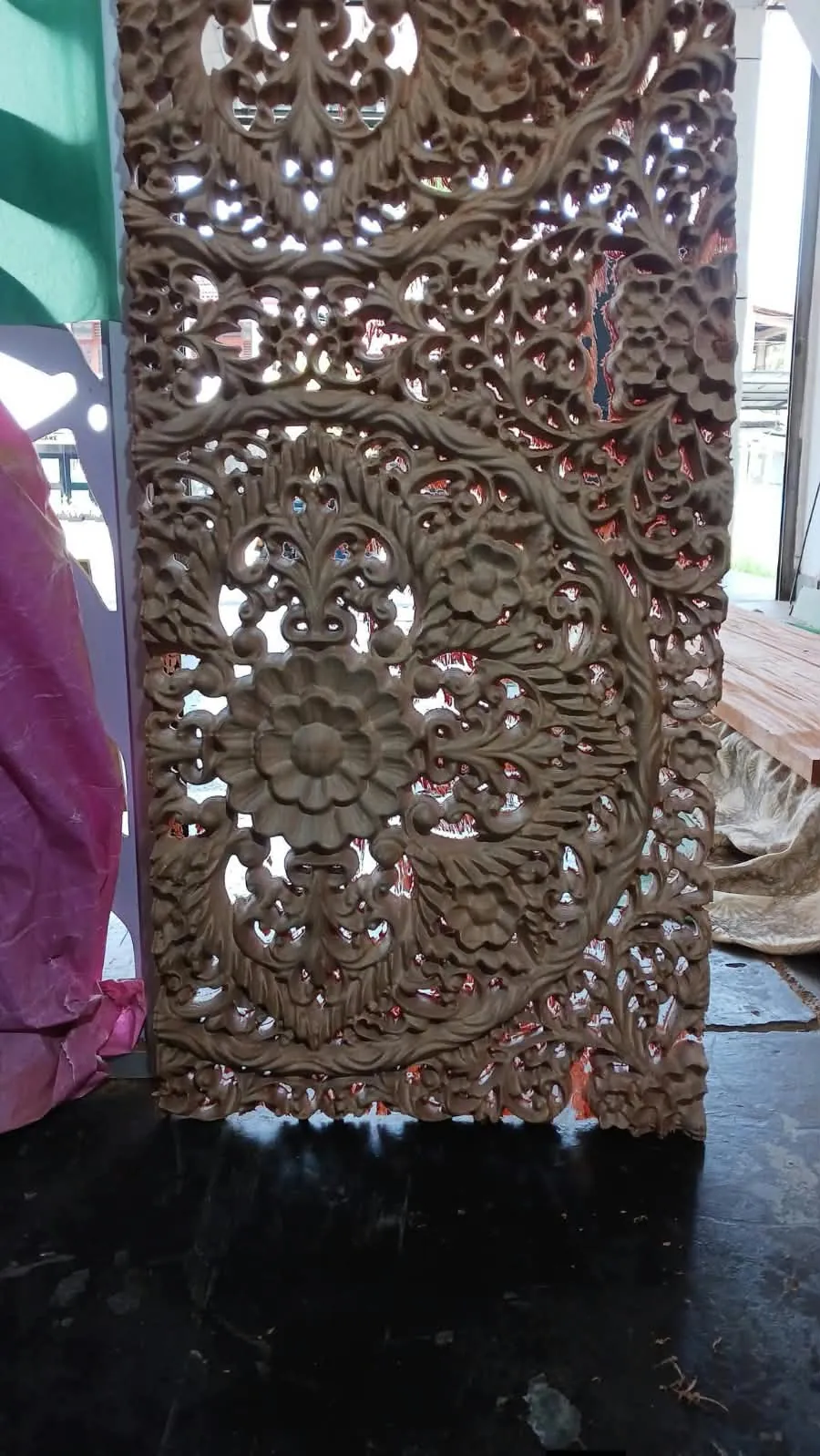 Tall carved mahogany decorative panel used as a room divider or feature wall