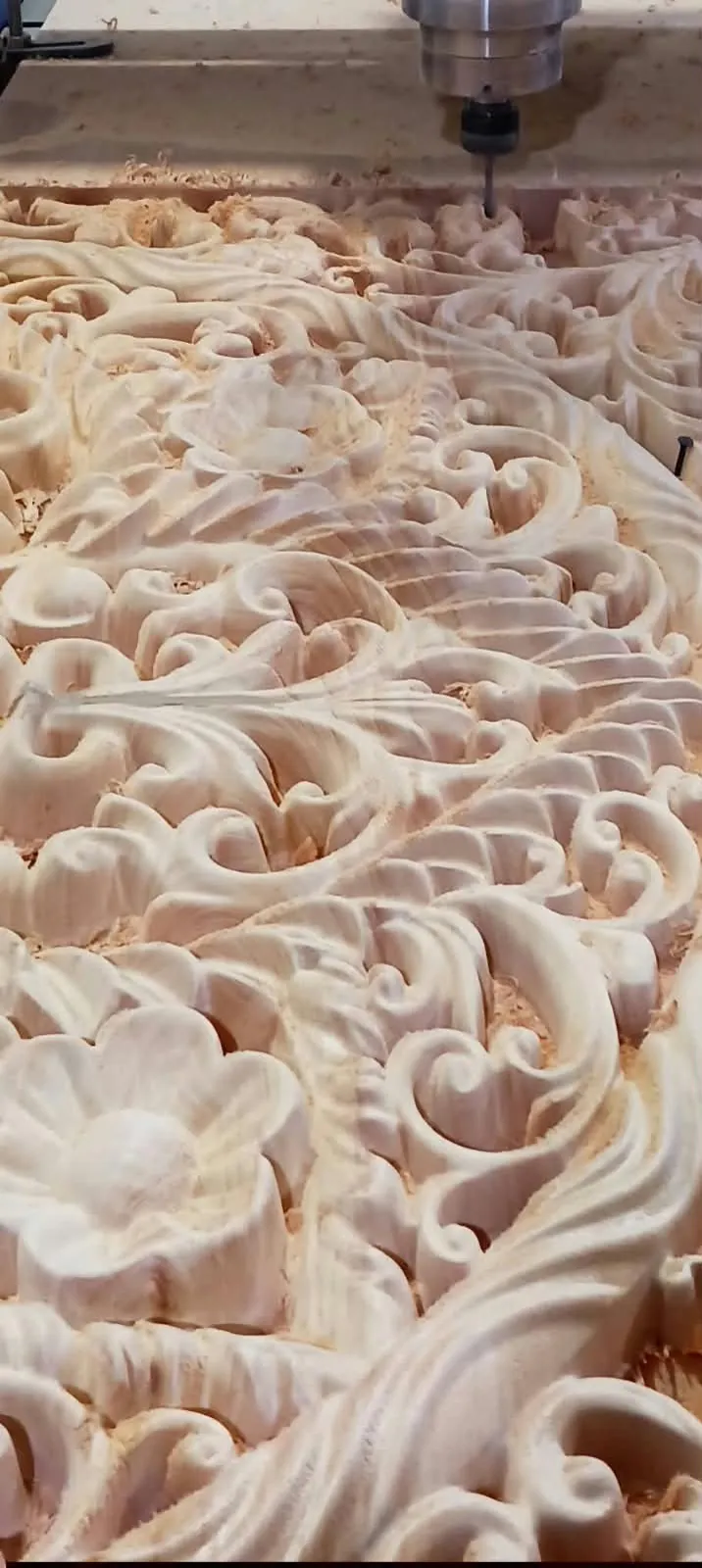 Close up of CNC wood carving on mahogany showing deep floral detail